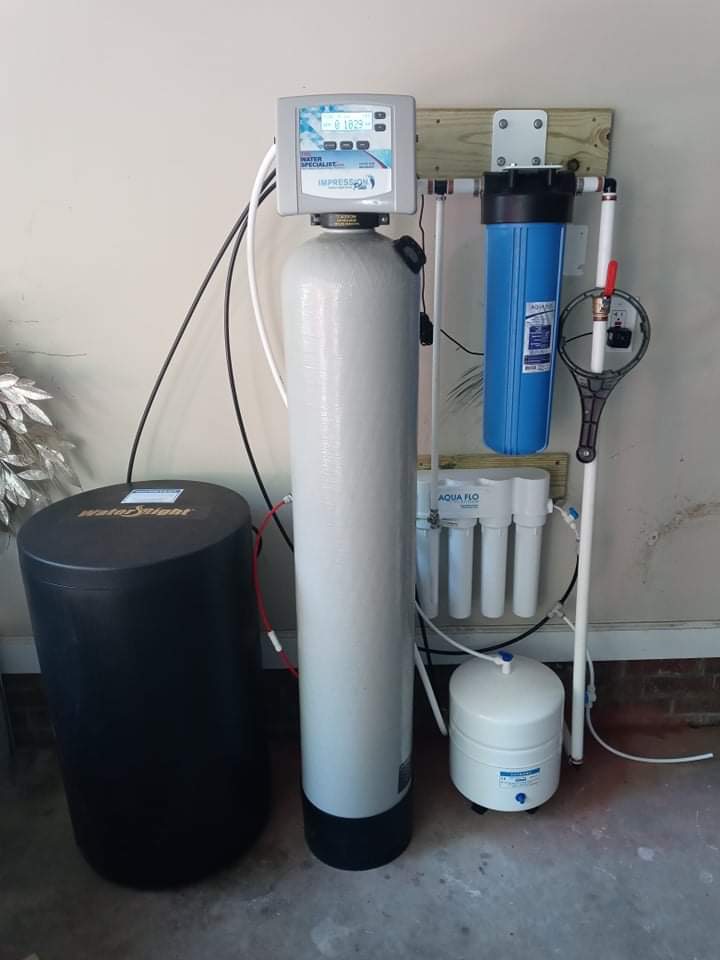 A water treatment system installed in the garage of a home.